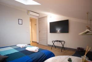 a bedroom with two beds and a flat screen tv at B&Big Prato in Prato