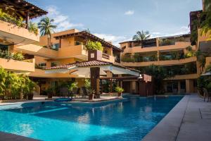 a swimming pool in front of a building at Residencial Los Mangos - Departamento 205 in Zihuatanejo