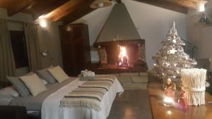a bedroom with a christmas tree and a fireplace at Studio apartment Cami - Cottage with a soul in Gračišće