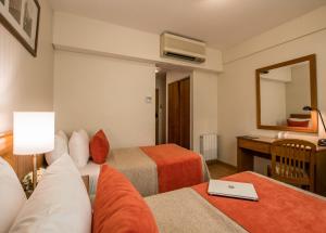 מיטה או מיטות בחדר ב-Hotel Solans Carlton