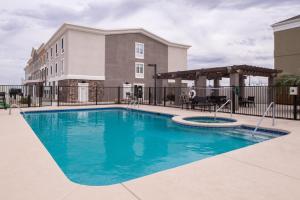 a pool at a hotel with a fence and a building at Holiday Inn Express Sierra Vista, an IHG Hotel in Sierra Vista