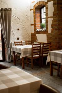 a dining room with a table and chairs at Gościniec Młyn in Chodecz
