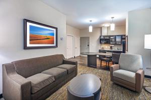 a living room with a couch and a kitchen at Candlewood Suites - Houston - Pasadena, an IHG Hotel in Pasadena