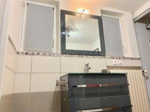 a bathroom with a mirror and a sink at Maison de campagne Chez Trabou et Loulou 20 min de La Rochelle in Aigrefeuille-dʼAunis +14 photos