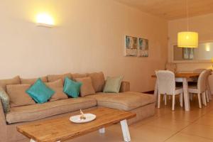 a living room with a couch and a table at Myra Luxury Seafront Apartment in Cap Malheureux