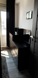 a black desk in a room with a window at Modern apartment fully equipped in Amsterdam