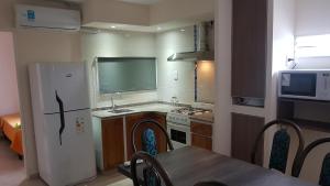 a kitchen with a refrigerator and a table and a microwave at Los Franceses in San Rafael +10 photos