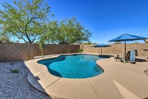 a small swimming pool with two umbrellas in a yard at Mtn-View Home with Pool and BBQ in Gold Canyon in Gold Canyon