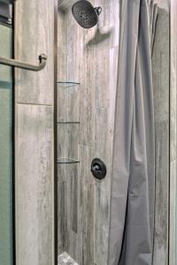 a shower with a glass door with a shower curtain at The Lakefront Home - 5 Minutes From Detroit Lakes! in Detroit Lakes +22 photos