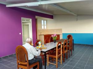 a man sitting at a table in a dining room at Casa Celeste in Ponta do Sol