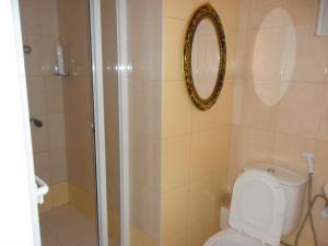 a bathroom with a toilet and a shower with a mirror at Casa Celeste in Ponta do Sol