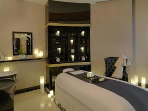 a bedroom with a bed and a table and candles at HotelApart Dubai Mall st with Full Burj Khalifa View in Dubai
