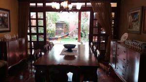 a dining room with a table and a large window at Garden House Miraflores in Lima