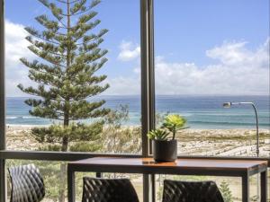 a table and chairs with a view of the ocean at Kirra Waves in Gold Coast