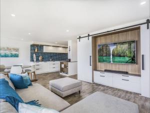 a living room with a couch and a tv at Kirra Waves in Gold Coast