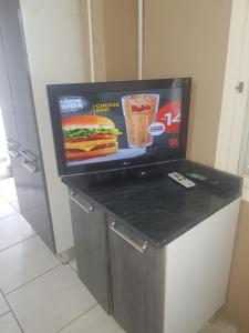 a fast food restaurant with a sandwich and drink on a counter at Apartamentos Imbe in Imbé