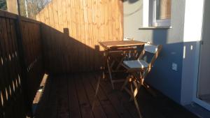 a desk and a chair on a wooden deck at Nad Strumykiem 2 in Duszniki Zdrój