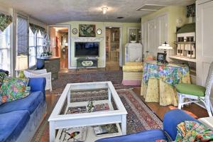 a living room with a blue couch and a table at Historic Grape Arbor House Less Than 2 Blocks to Main St in Fredericksburg