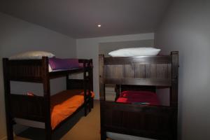 a room with three bunk beds in a room at Breakers Holiday House in Lorne