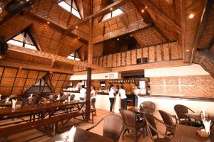 a group of people standing in a restaurant at Pyramid Resort in Panglao Island