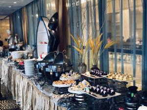 a buffet line with appetizers and desserts on tables at Royal Mediterranean Hotel in Guangzhou