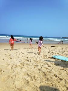 a group of children playing on the beach at Warilla Sands in Lake Illawarra