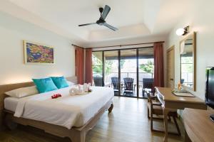 
a hotel room with two beds and a television at Phi Phi Bayview Resort in Phi Phi Don
