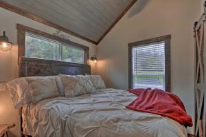 a bedroom with a bed and a large window at Secluded Morganton Tiny Home with Hot Tub Access! in Morganton