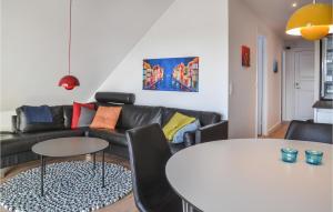 a living room with a couch and a table at Amazing Apartment In Vejers Strand With 2 Bedrooms And Wifi in Vejers Strand