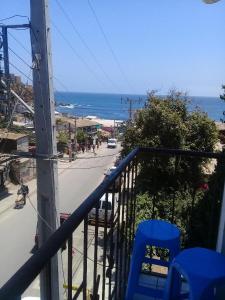 uma varanda com vista para uma rua e para o oceano em Habitaciones Gabriel em Horcón