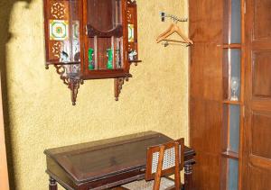 a room with a table and a cabinet on the wall at The Ferreiras in Mumbai