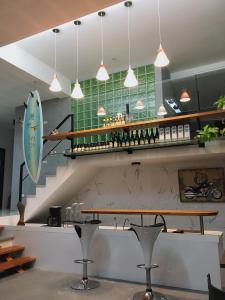 a bar with pendant lights and a staircase at BEACH FRONT VILLA in Baisha