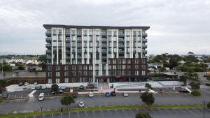 a large building with a lot of windows on top of it at Ramada Suites by Wyndham Manukau in Auckland