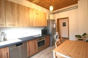 a kitchen with wooden cabinets and a wooden table at Charmante Wohnung ruhig und zentral gelegen in Mannheim