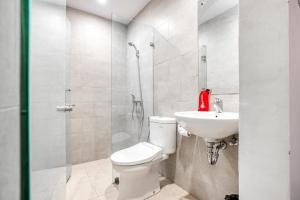 a bathroom with a toilet and a sink at Puri Maju Hotel in Jakarta +34 photos