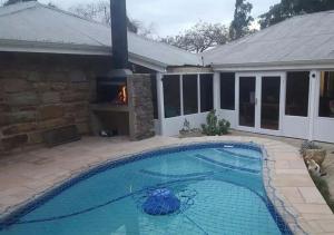 a swimming pool in front of a house at Country Lane Guesthouse in Howick