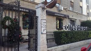 a store with christmas wreaths on the windows of a building at Apartment Tesla Wizard in Belgrade
