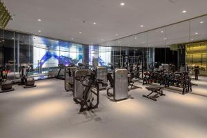 a gym with several treadmills and exercise bikes at Hotel Indigo Shanghai Jing'An, an IHG Hotel in Shanghai