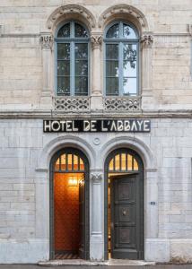 an old building with a sign on the front of it at Hôtel de l'Abbaye - Lyon in Lyon