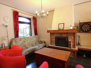 a living room with a couch and a fireplace at Welcoming Mansion with Sauna in Herbeumont in Herbeumont