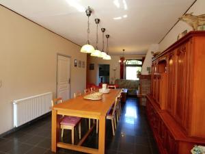 a dining room with a wooden table and chairs at Welcoming Mansion with Sauna in Herbeumont in Herbeumont