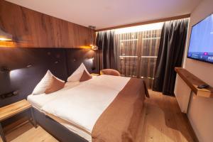 Ein Bett oder Betten in einem Zimmer der Unterkunft Gourmethotel Yscla