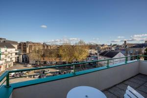 a balcony with a view of a city at Le Mancini - Parking et Terrasse in Mayenne