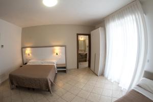 Postel nebo postele na pokoji v ubytování Hotel Victoria