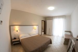 Postel nebo postele na pokoji v ubytování Hotel Victoria