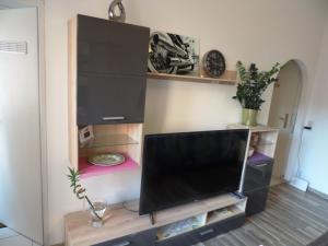 a living room with a flat screen tv at Budget Friendly Private Apartment in Sindelfingen