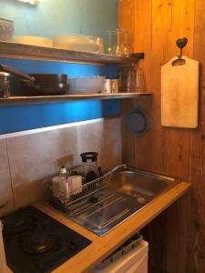 a kitchen sink with a dish rack next to it at Sunrise Cabin et Sauna in Rothbach