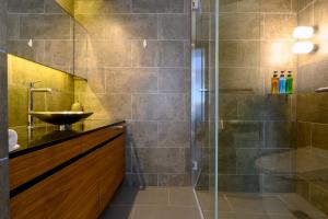 a bathroom with a glass shower and a sink at Sekka Sekka in Niseko