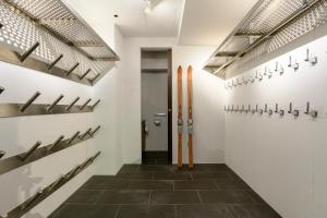 a hallway with hockey racks and skis on the wall at Sekka Sekka in Kutchan
