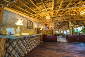 a lobby of a resort with a bar and a restaurant at Bora Bora Villa Phuket in Chalong